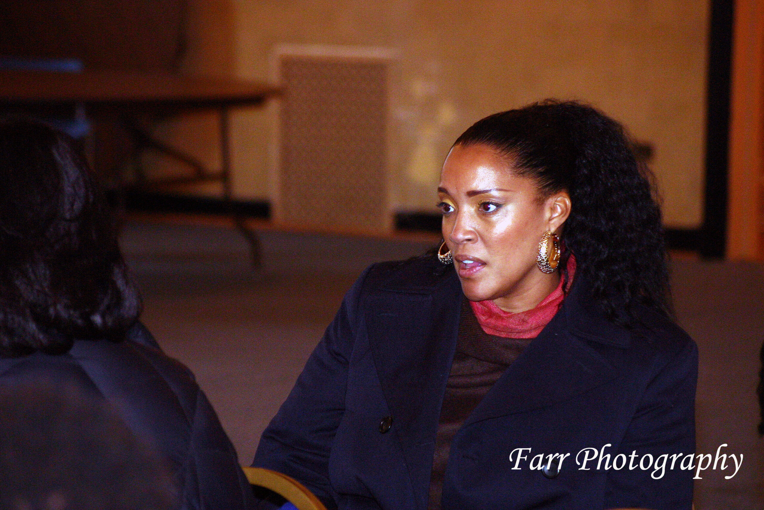 Sandra Ekpenyong speaking with a guest at an EWEV event