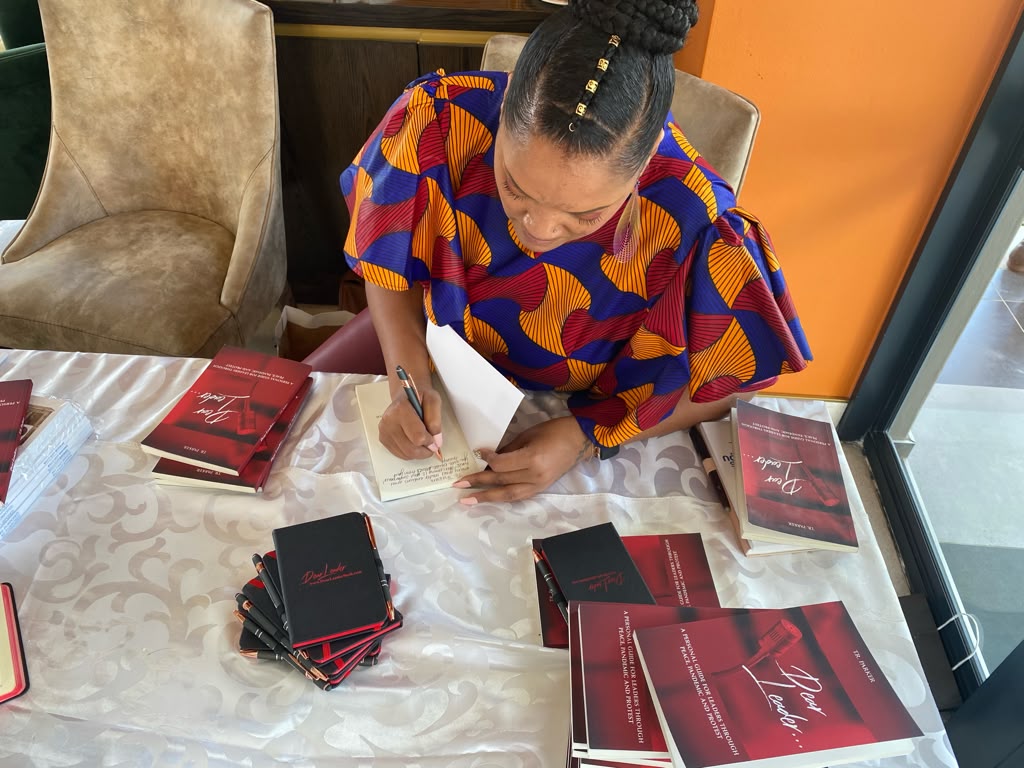 Tiffany Parker signing copies of Dear Leader